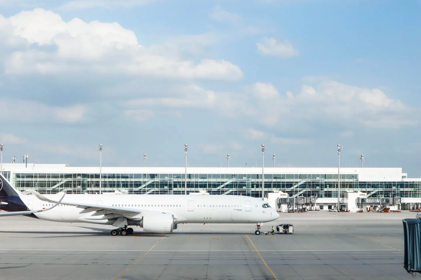 An airliner parked on an airport apron under a clear sky
